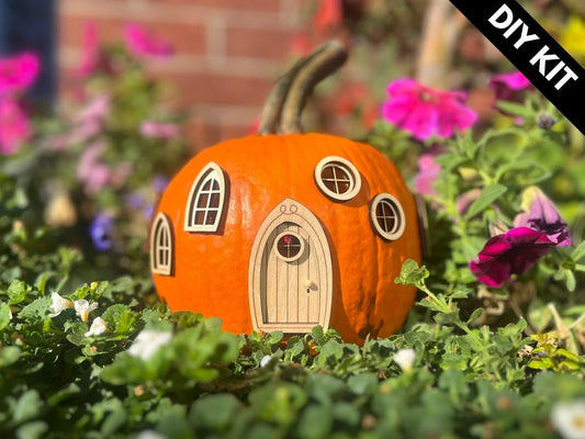 DIY pumpkin fairy house with wooden fairy door and windows